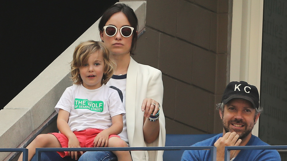 Olivia Wilde and Jason Sudeikis at a tennis match with their son Otis