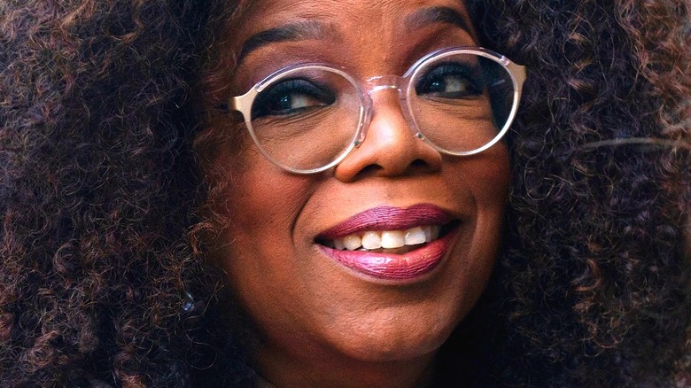 Oprah smiling wearing glasses