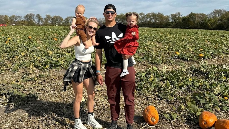 The Mahomes family posing in pumpkin patch