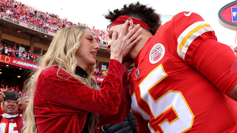 Brittany Mahomes grabbing Patrick Mahomes' face