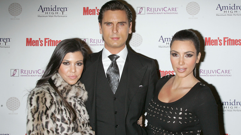 Kourtney Kardashian, Scott Disick, and Kim Kardashian posing