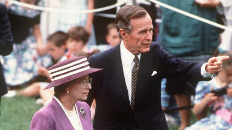 George H.W. Bush walks with Queen Elizabeth II 