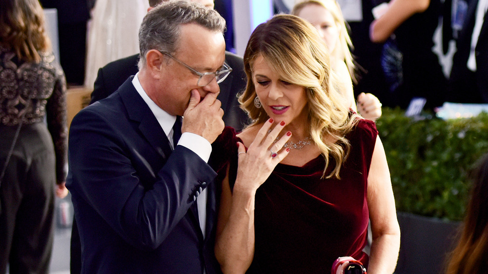 Tom Hanks and Rita Wilson whispering