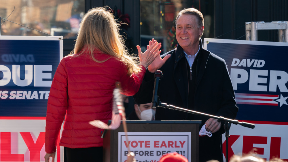 Kelly Loeffler and David Perdue high five