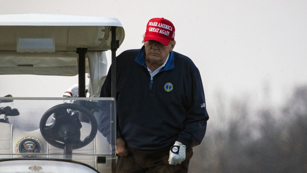 Donald Trump getting into golf cart