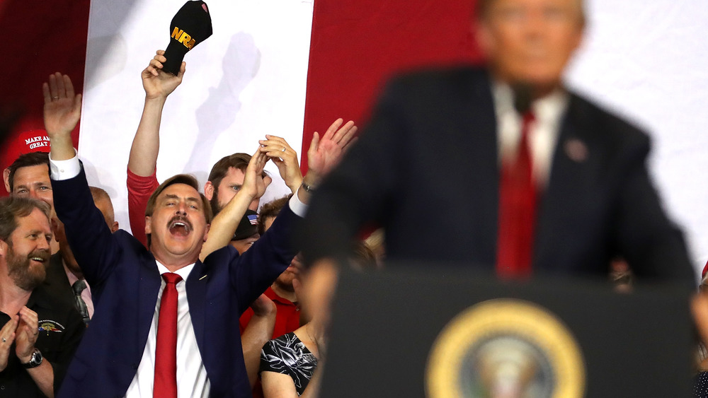 Mike Lindell cheering behind Trump 