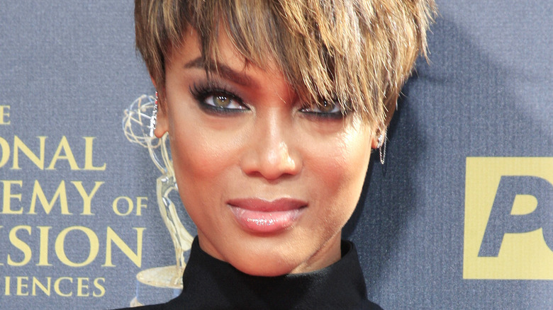 Tyra Banks with short hair and slight smile