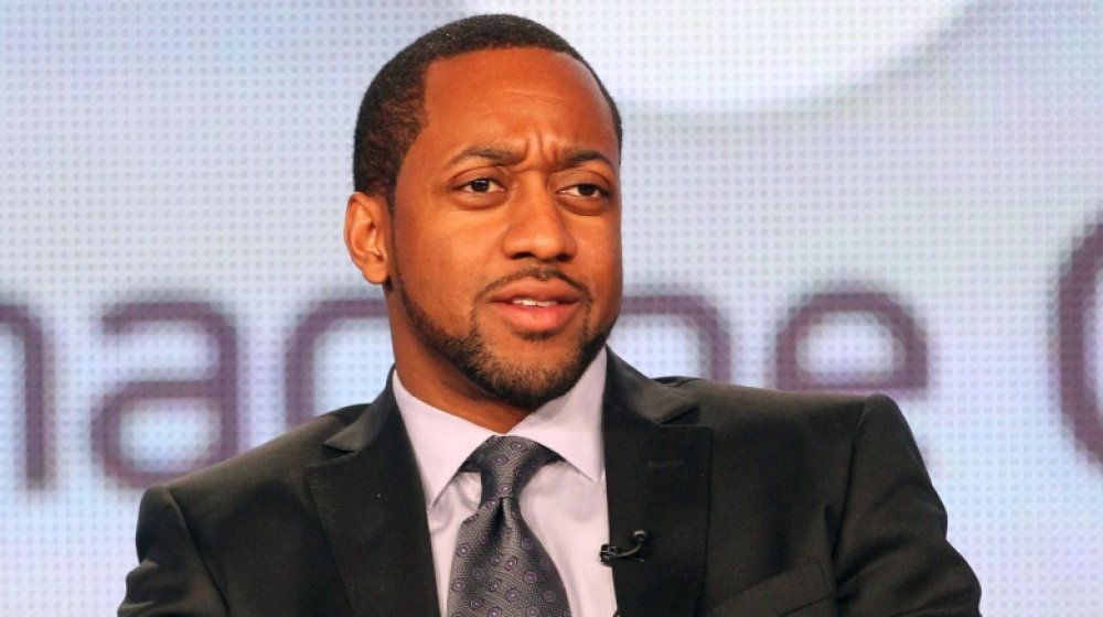 Jaleel White with a serious expression at a panel in 2012