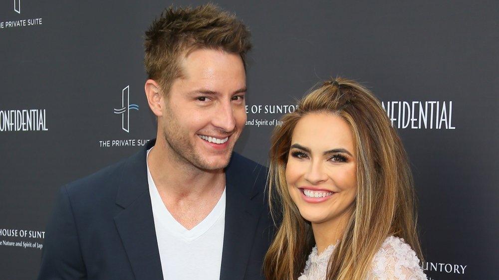 Justin Hartley, Chrishell Stause smiling on the red carpet