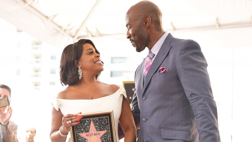 Niecy Nash, Jay Tucker looking at each other and smiling