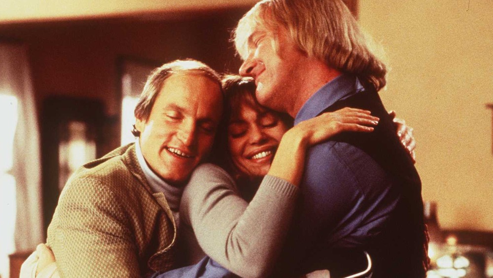 Woody Harrelson, Vanessa Angel, and Randy Quaid hugging