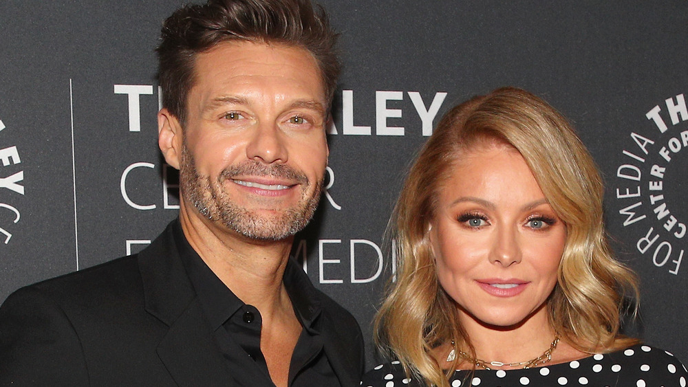 Kelly Ripa and Ryan Seacrest posing on red carpet