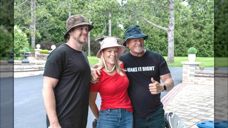 Mike Holmes Jr., Sherry Holmes, and Mike Holmes Sr. posing for photo together