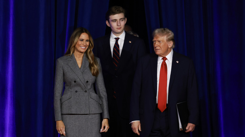 Barron Trump standing behind Melania and Donald Trump