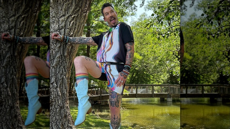 David Bromstad posing next to tree