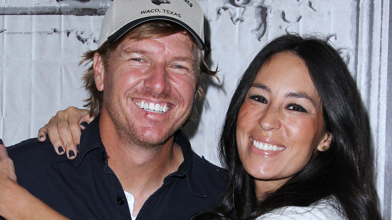 Chip and Joanna Gaines smiling and hugging