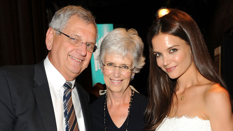 Katie Holmes and her parents at an event, smiling