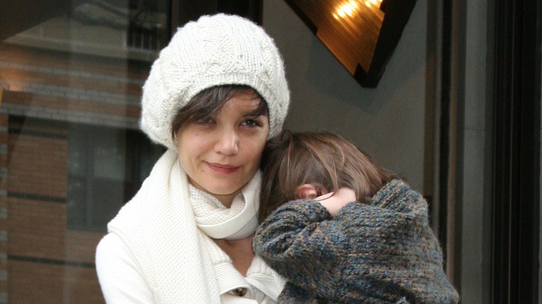 Katie Holmes carrying Suri outside