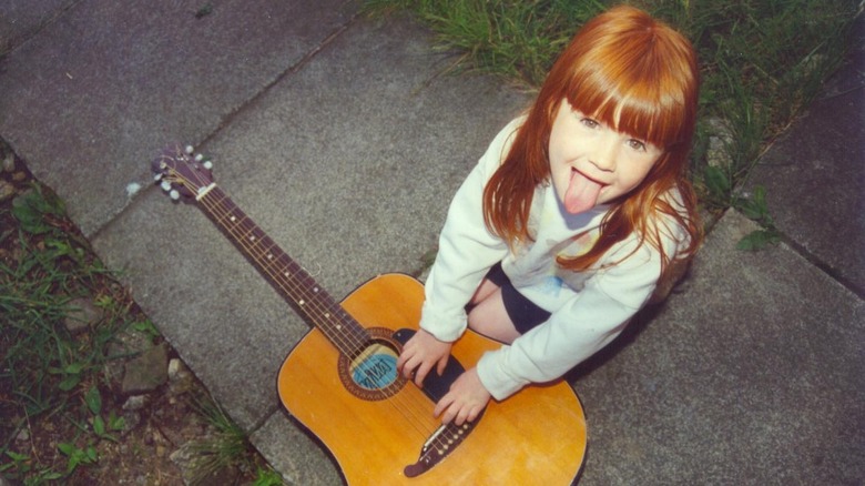 Young Karen Gillan with guitar