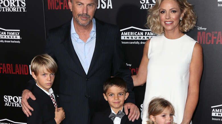 Kevin Costner poses with wife and kids on the red carpet