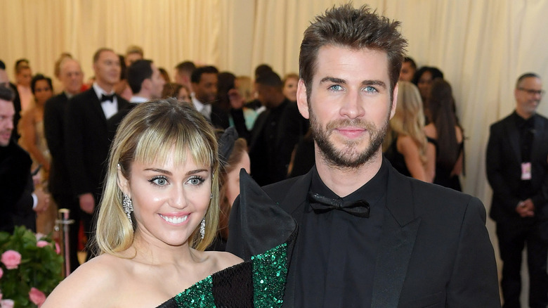 Miley Cyrus and Liam Hemsworth posing