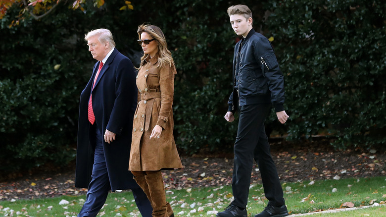 Barron Trump walks behind Melania and Donald