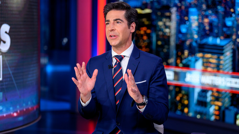 Jesse Watters appearing on his show with his hands up.