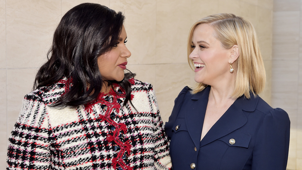 Mindy Kaling and Reese Witherspoon posing with arms around each other