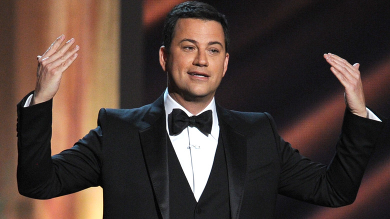 Jimmy Kimmel gesticulates on awards show stage