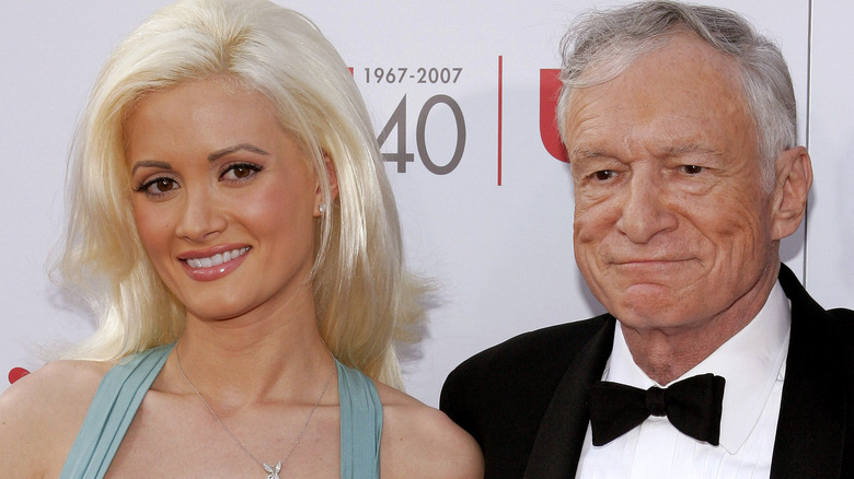 Holly Madison and Hugh Hefner posing