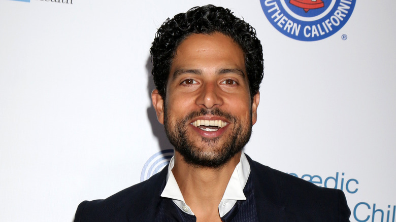 Adam Rodriguez with a white collar