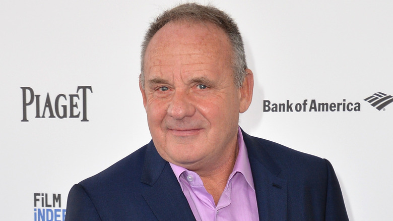 Paul Guilfoyle wearing purple shirt