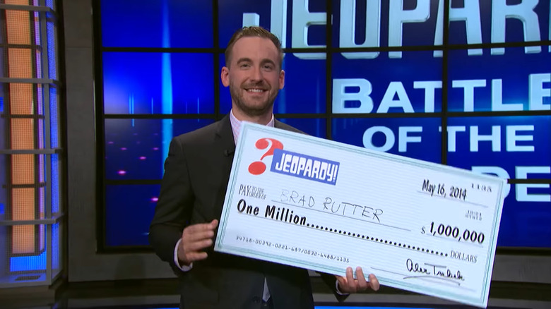 Brad Rutter holding a large check on Jeopardy!