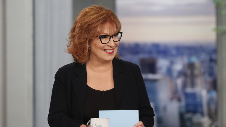 Joy Behar standing by desk