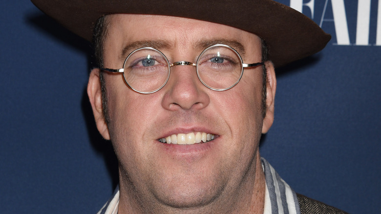 Chris Sullivan, round glasses, half smile