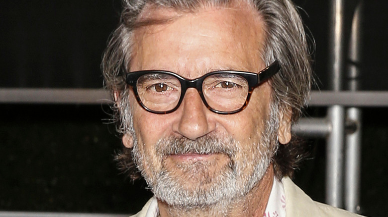 Griffin Dunne wearing glasses, mouth closed