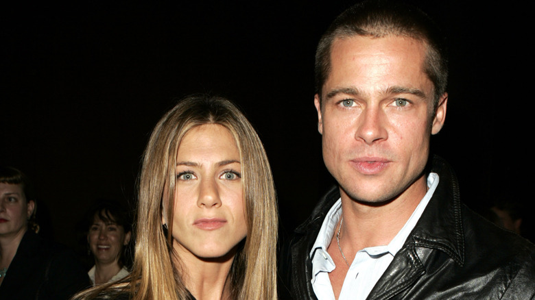 Jennifer Aniston posing with then-husband Brad Pitt in late 2004