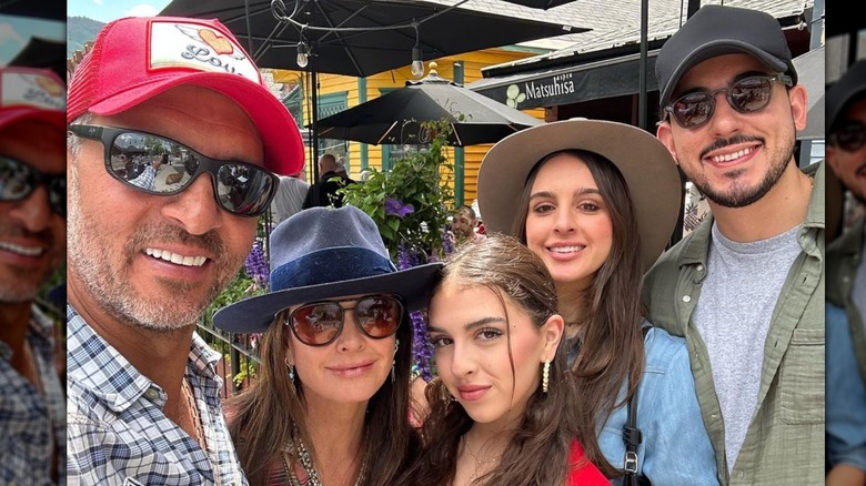 Kyle Richards and Mauricio Umanksy posing together with Portia, Alexia, and Jake Zingerman