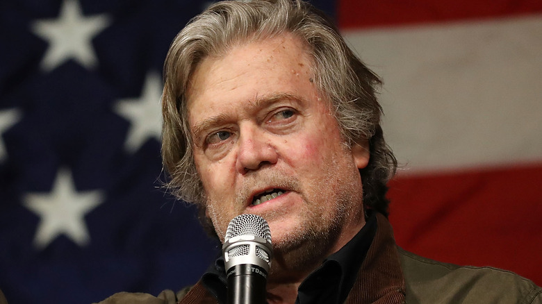 Steve Bannon speaking in front of the American flag