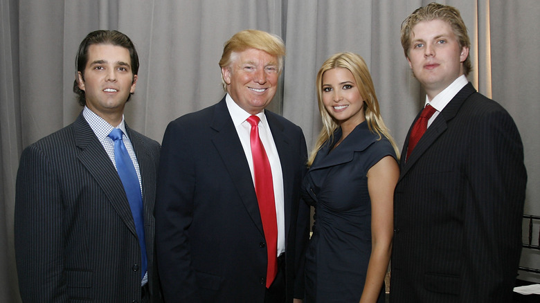 Donald Trump posing with his kids Donald Jr., Eric and Ivanka