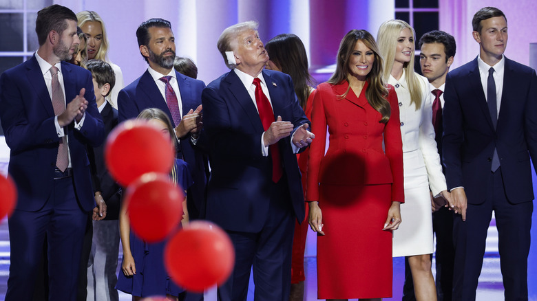 The Trump family on stage with balloons falling around them