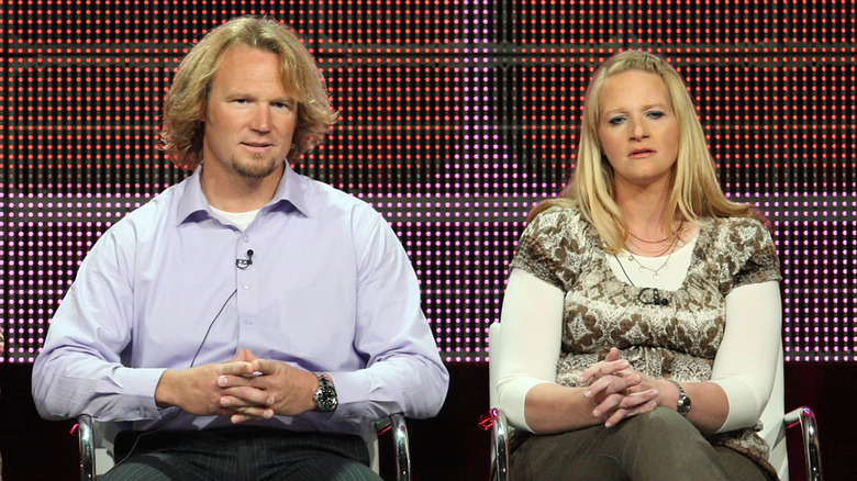 Kody and Christine seated on stage