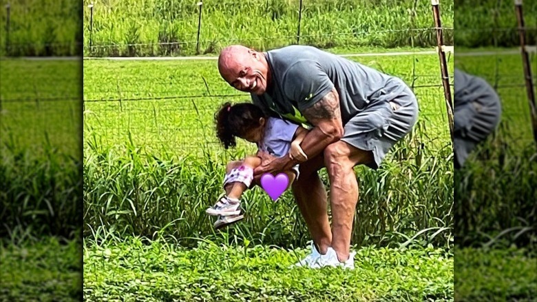 The Rock holding his daughter