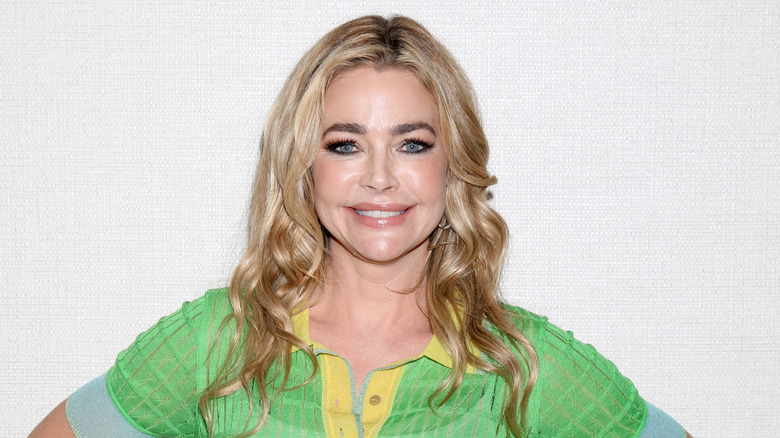 Denise Richards poses in a green top