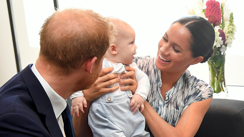 Prince Harry and Meghan Markle with their son