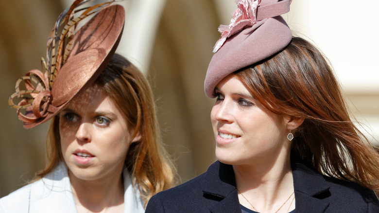 Princess Beatrice and Princess Eugenie in close-up with elegant hats