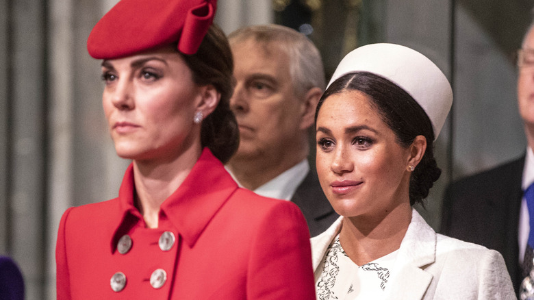 Kate Middleton and Meghan Markle frowning 