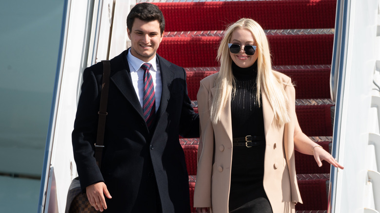 Michael Boulos and Tiffany Trump disembarking Donald Trump's plane.