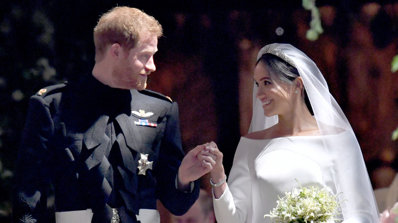 Prince Harry and Meghan Markle hold hands at their wedding