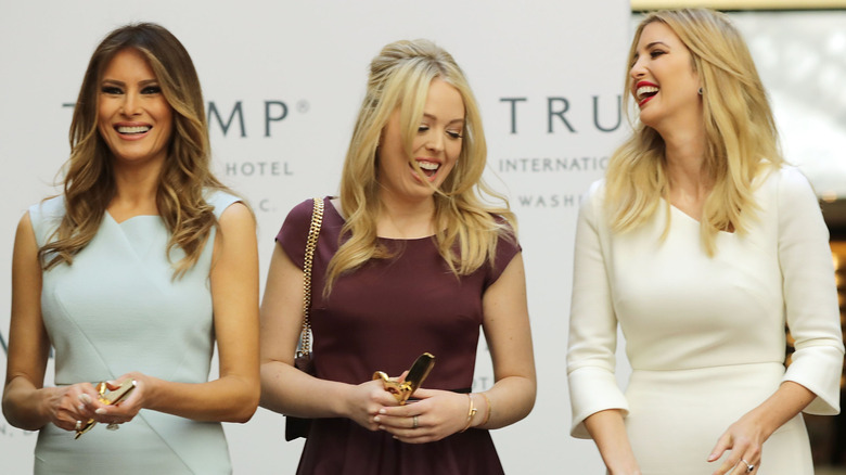 Melania, Tiffany, and Ivanka Trump cutting a ribbon